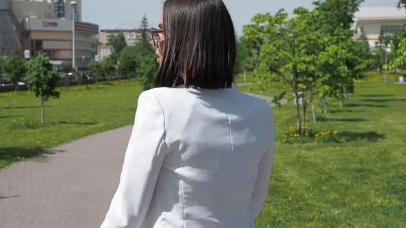 Stylish Woman Walking on Path in Park