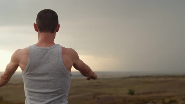 Man of Athletic Build Performs Warmup Before Training