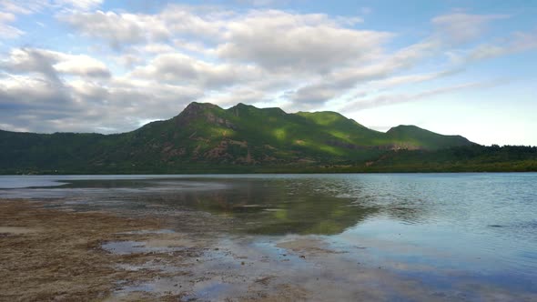 Waterside View of Green Forested Hills