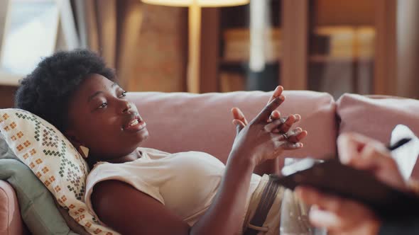 African American Woman Lying on Couch and Talking to Psychologist