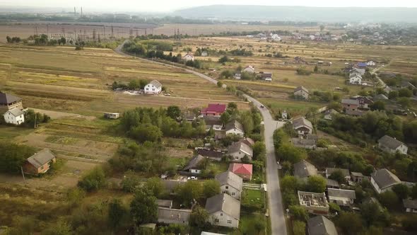 Aerial landscape of small town or village with rows of residential homes and green trees