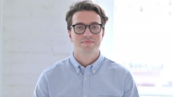 Portrait of Young Man Saying Yes By Shaking Head