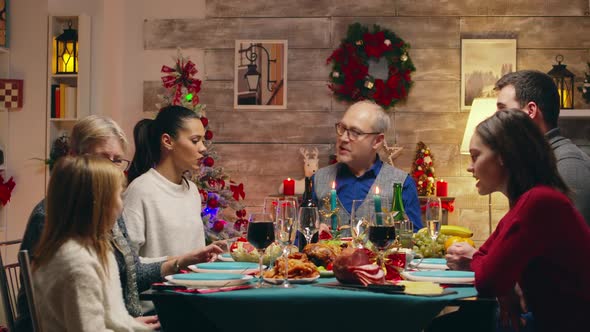 Grandfather at the Head of the Table While Celebrating Christmas