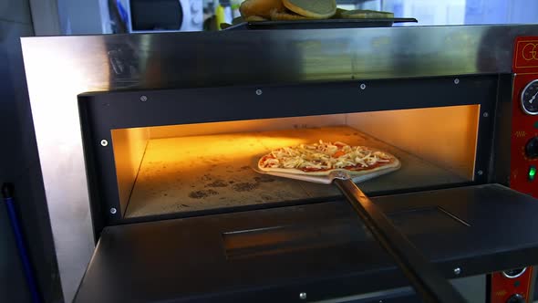 Freshly Prepared Pizza on a Wooden Table in a Cafe. 