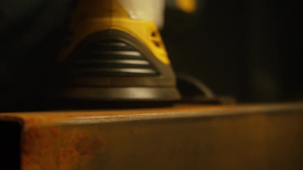 Worker polishing metal with grinder