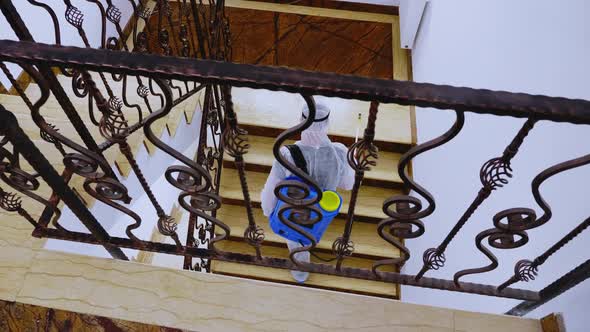 Man Wearing Full Hazmat Suit Sprays Disinfectant