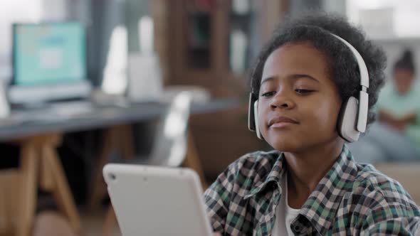 Afro Boy Enjoying Music In Headphones