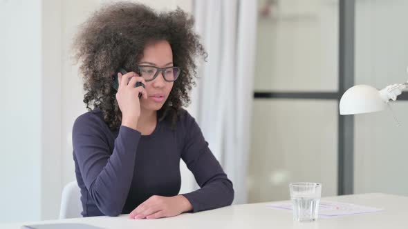 Angry African Woman Talking on Smartphone