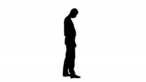 Man Walks Around the Room, He Is Tired of Work. Silhouette. White Background
