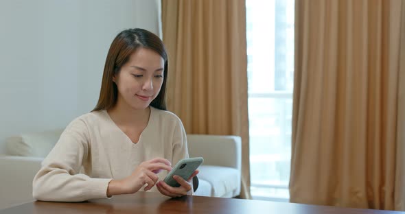 Woman use cellphone online at home