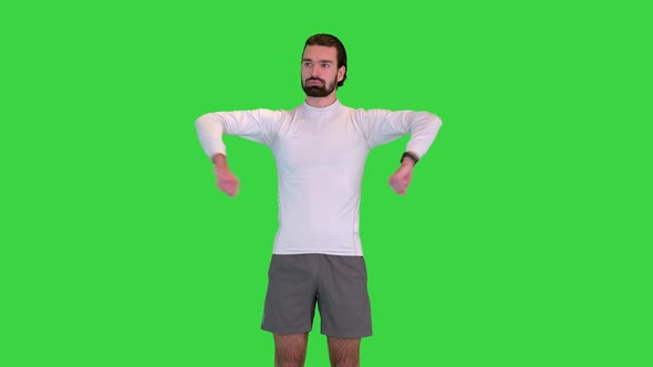 Man Warming Up His Elbows Rotating His Hands on a Green Screen Chroma Key