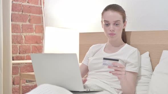 Young Female Making Online Payment on Laptop