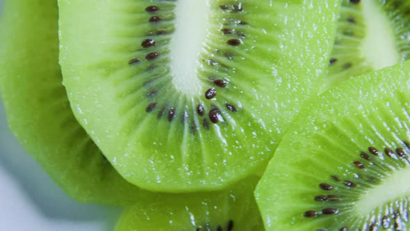 Green Citrus Fruit Slices of Kiwi on Rotating Surface Close Up Top View