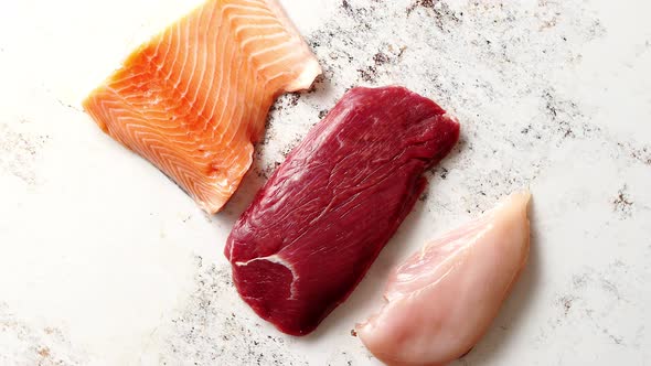 Fresh Raw Beef Steak, Chicken Breast, and Salmon Fillet