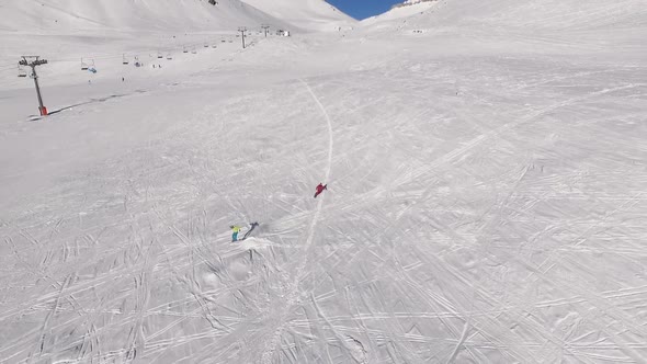 Two Males Riding Ski and Snowboard From Mountains Slope in Slowmotion