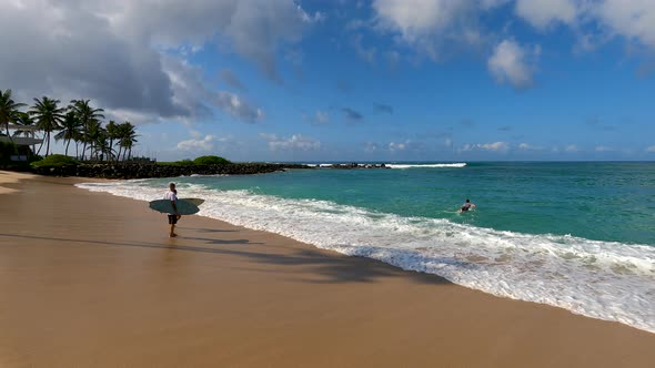 Surfers Running To The Ocean