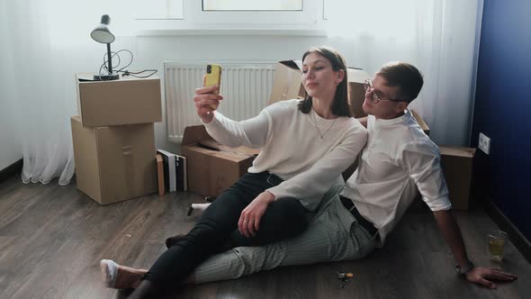 Happy Couple Relaxes After Moving in a New Home