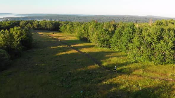 Aerial shot a man running across the land Knox County Maine USA