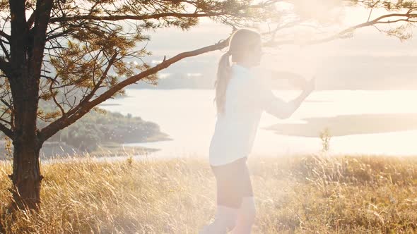 Young Woman Playing with Swords on the Hill  Midges Flying Around