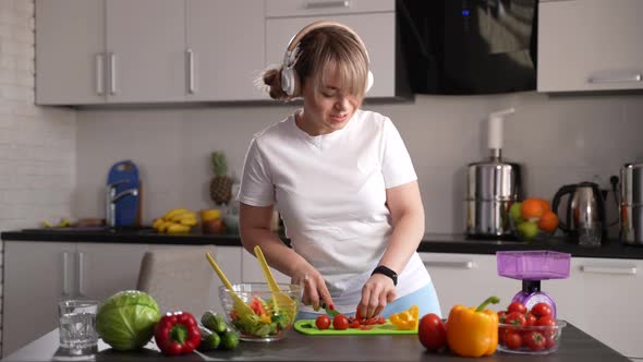 Cheerful Woman Listening to Music in Home Kitchen