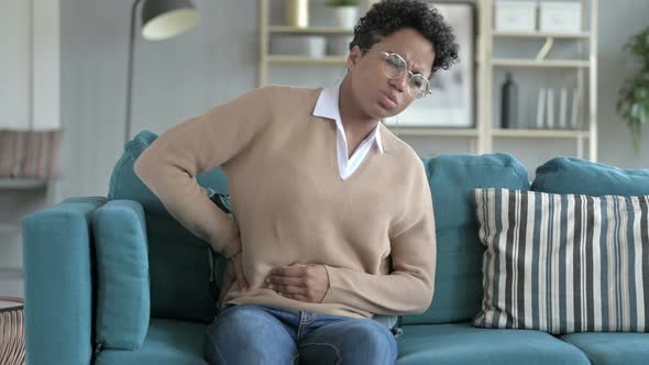 Uncomfortable Young African Girl Grabbing Her Waist in Pain