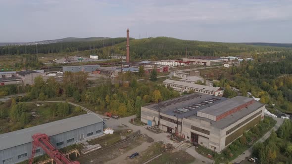 Large area with industrial buildings. Train moving nearby 19