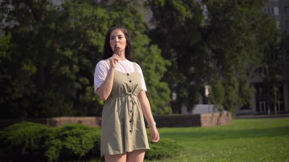 Young Attractive Woman Waliking Eating Ice Cream Outdoors Summer Vacation