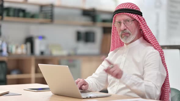 Attractive Senior Old Arab Businessman with Laptop Showing No Sign