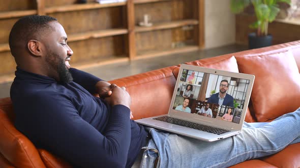 AfricanAmerican Male Employee Using Laptop for Video Call Indoor