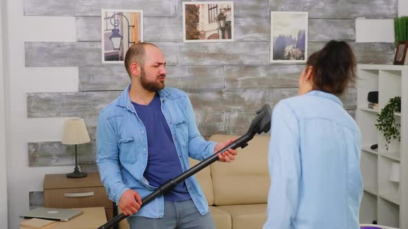 Couple Singing and Dancing While Cleaning the House