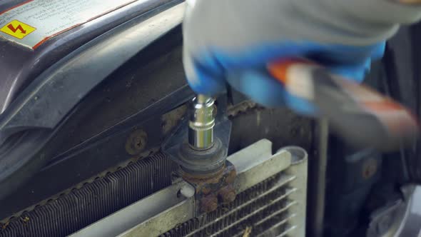 Workshop, locksmith work. The master unscrews the nut with the head