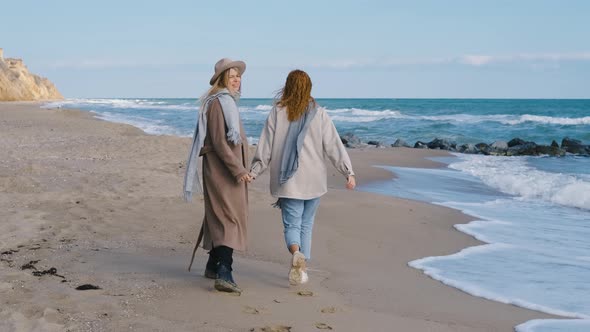 Beautiful Girls Walk Near the Sea