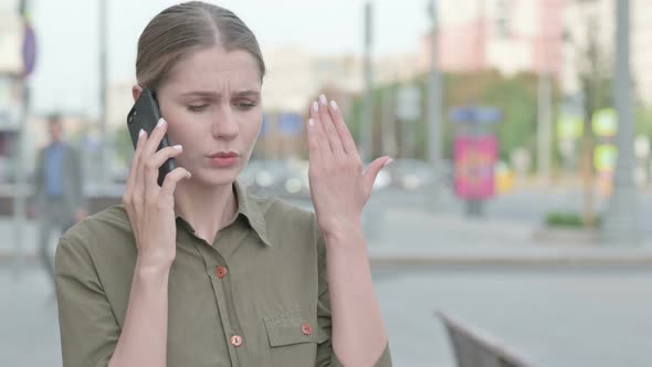 Angry Woman Talking on Phone Outdoor