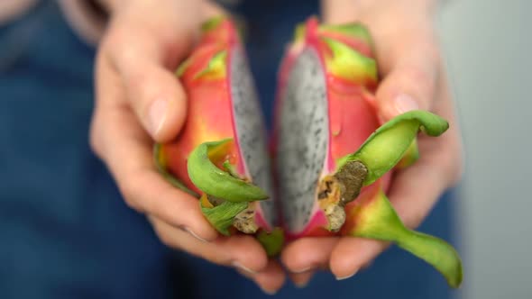 Female Hands Holding Fresh Ripe Organic Dragon Fruit or Pitaya Pitahaya