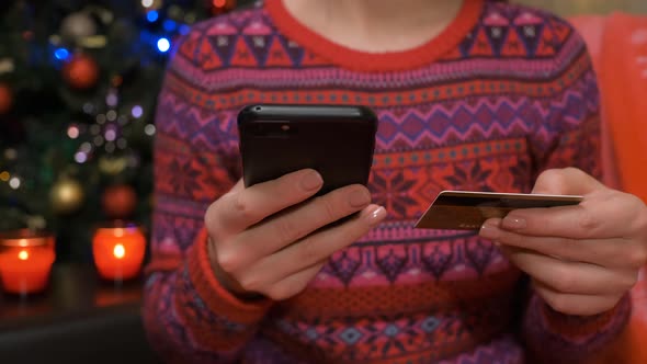 Closeup Hand of Woman Online Shopping in Christmas with Credit Card