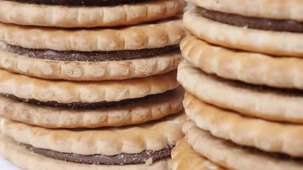 Pile of filled sandwich cookies close-up  slow tilt 4K 2160p 30fps UltraHD footage - Sandwich biscui