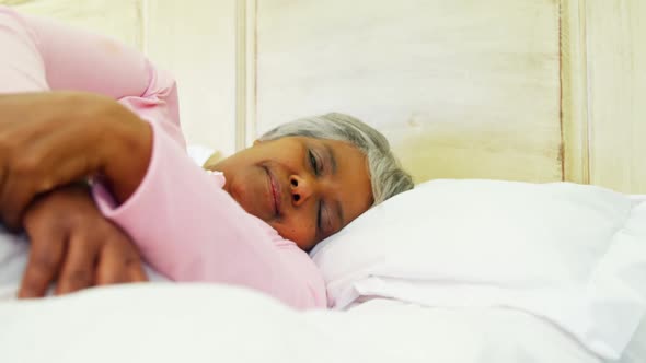 Granddaughter comforting sick grandmother in bed room