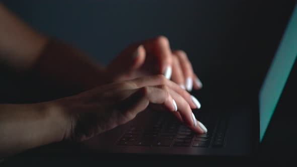 Hands or Woman Office Worker Typing on the Keyboard at Night