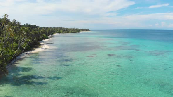 Aerial: flying over exotic white sand beach tropical island secluded destination away from it all