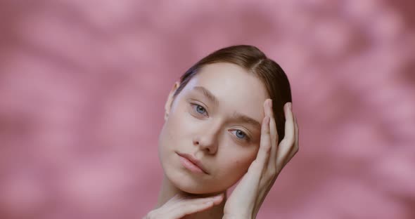 Caucasian Model with Natural Beauty Posing Touching Her Face with Her Hands