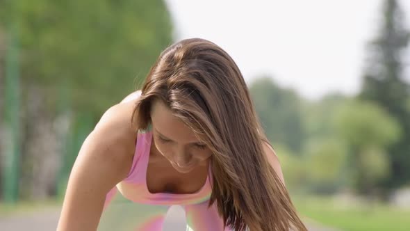 Portrait of young brown-haired woman outdoor at sport playground