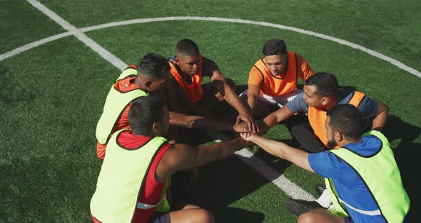 Soccer players motivating on the field