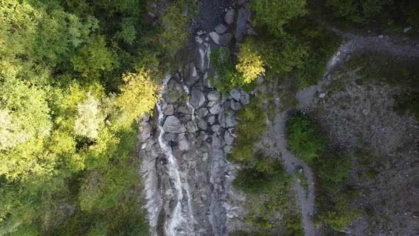 Aerial approach of a small river in the french alps