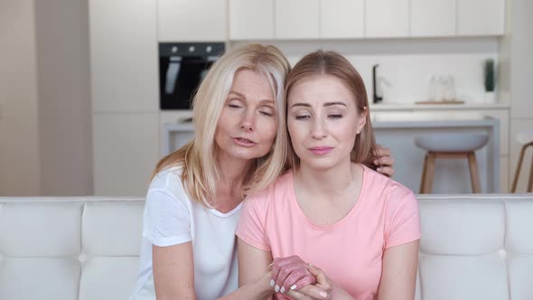 Worried Mature Mother Comforting Depressed Grown Daughter