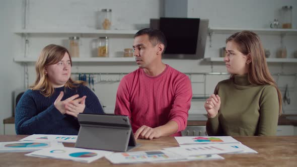 Deaf-mute Freelancers Brainstorming in Kitchen