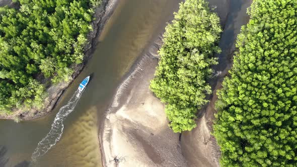 Aerial view of small boat riding on river in Thailand
