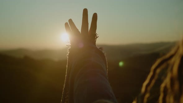 Close-up of hand at sunrise. Freedom concept.