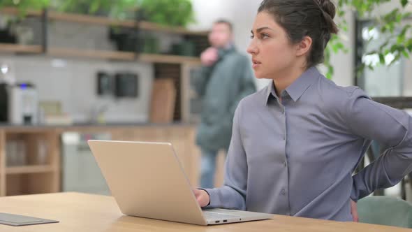 Indian Woman Having Back Pain While Using Laptop