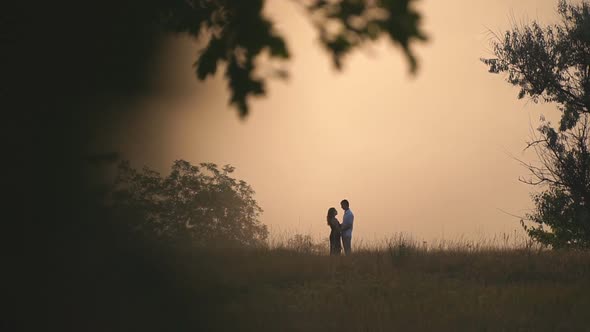 Young Man and Woman Hugging and Showing Love Feelings on Beautiful Summer Evening