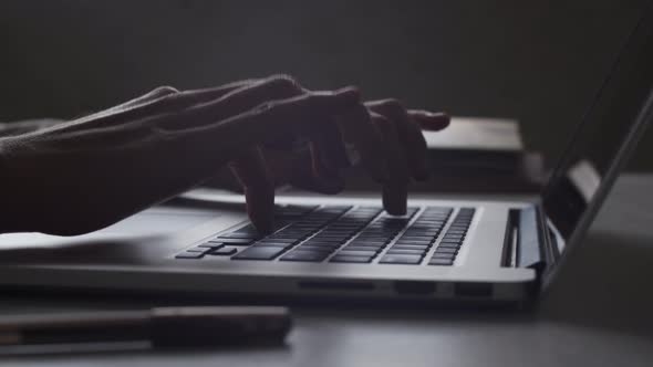 4K Close up. Hands typing on laptop keyboard. Person works in office on computer, technology.